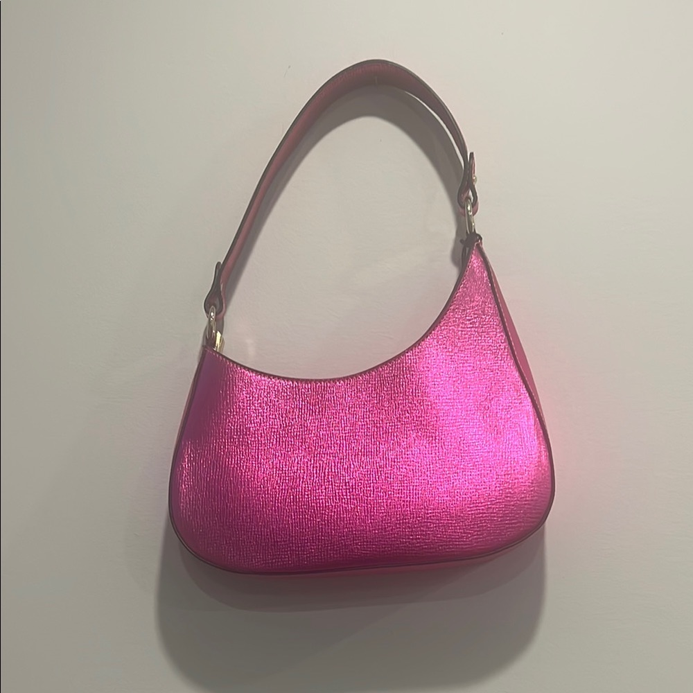 Vibrant Pink Metallic Shoulder Bag with Crescent Shape with strap.